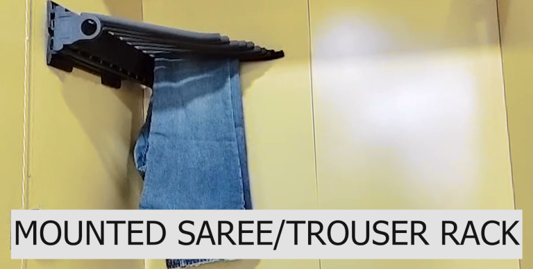 A securely mounted rack for hanging sarees and trousers in a wardrobe.